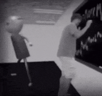 a black and white photo of a boy writing on a blackboard ..