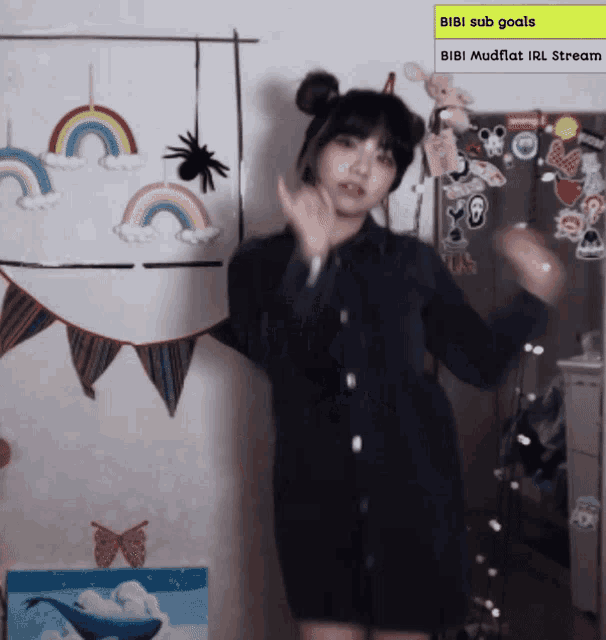 a girl dancing in front of a sign that says bibi subs goals