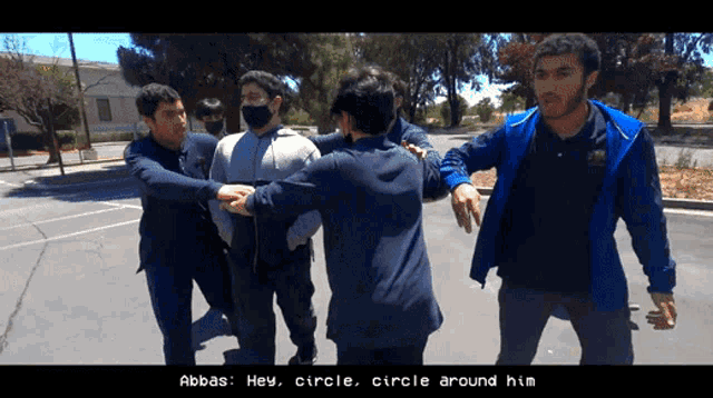 a group of men are standing around a man wearing a mask with the words abbas hey circle circle around him below them