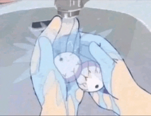 a person is washing their hands in a sink while holding a small object .