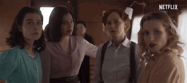 a group of women standing next to each other with a netflix logo on the bottom