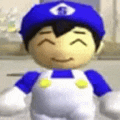 a close up of a stuffed animal wearing overalls and a blue hat .