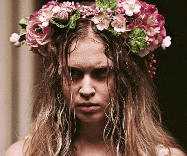 a woman wearing a flower crown on her head