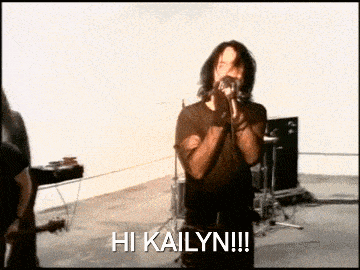 a man singing into a microphone with the words hi kailyn on the bottom