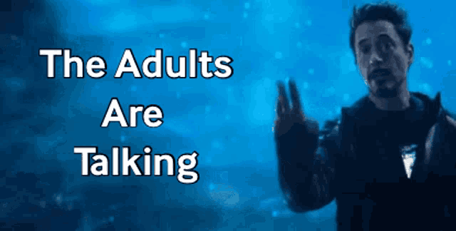 a man in a black jacket stands in front of a blue background with the words " the adults are talking "