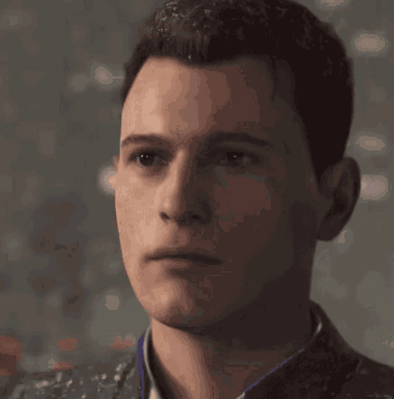 a close up of a young man 's face with a serious look on his face