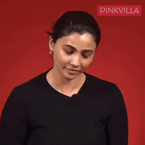 a woman in a black shirt is making a face and says forget it