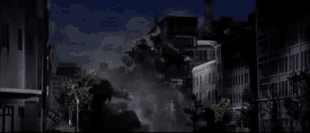 a city at night with a lot of buildings and trees