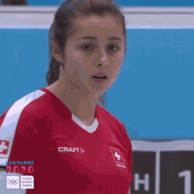 a girl wearing a red shirt with craft on it