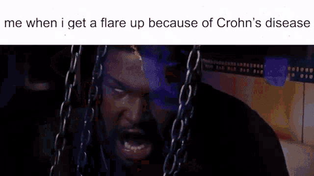 a man with chains around his neck is screaming because of crohn 's disease