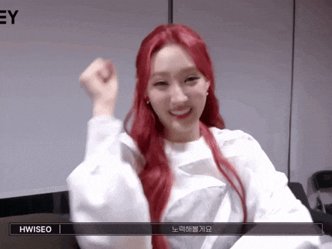 a woman with red hair is wearing a white shirt and has the name hwiseo on the bottom