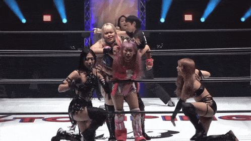 a group of women are in a wrestling ring with the letters tc on the bottom