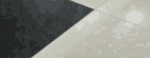 a black and white checkered tile floor with a diagonal stripe .