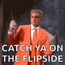 a man in an orange suit and tie is saying `` catch ya on the flipside '' while holding a stick .