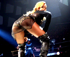 a woman in a very revealing outfit is dancing on stage