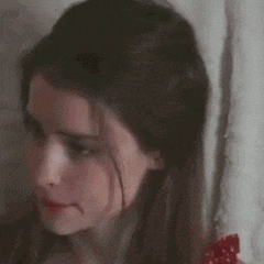a woman is making a surprised face with her mouth open .
