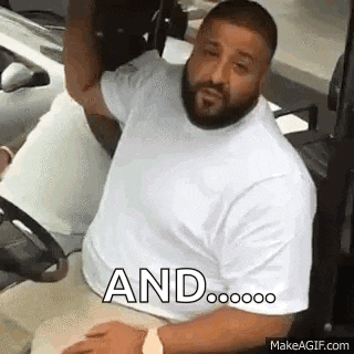 a man with a beard is sitting in a golf cart and looking at the camera .