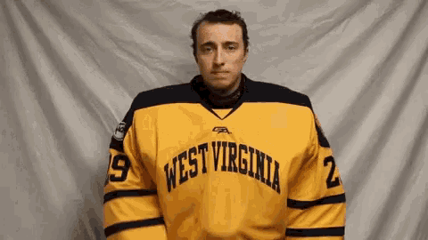 a man in a yellow west virginia jersey with the number 2 on it