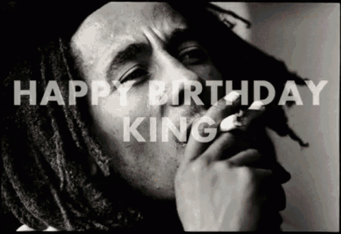 a black and white photo of a man smoking with the words happy birthday king