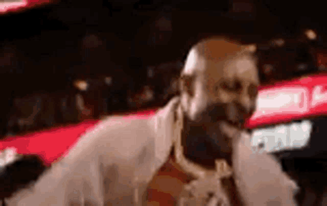 a man is singing into a microphone in front of a crowd of people .