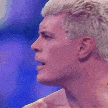 a close up of a man 's face with a purple background