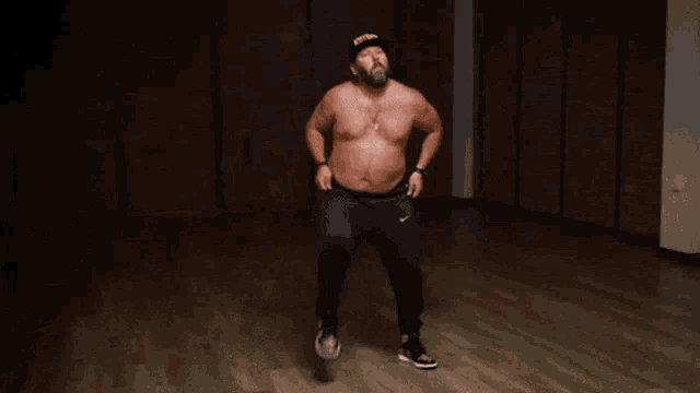 a shirtless man wearing a hat that says ' sfw ' on it