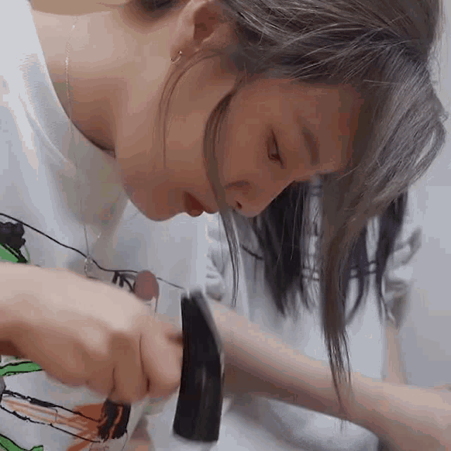 a close up of a woman holding a hammer on her wrist .