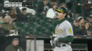 a baseball player wearing a green and white uniform with the number 8 on the back