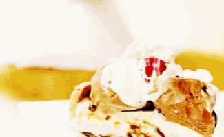 a piece of cake with whipped cream and a cherry on top