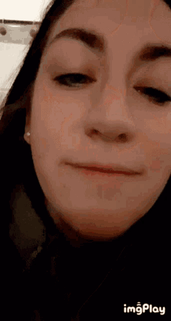 a close up of a woman 's face with the words " imgplay " at the bottom