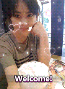 a woman sits at a table with a cup of coffee and a welcome message