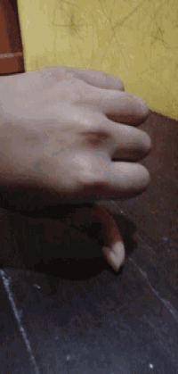 a close up of a person 's hand with a ring on it