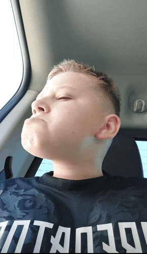 a young boy wearing a black shirt that says titan on it