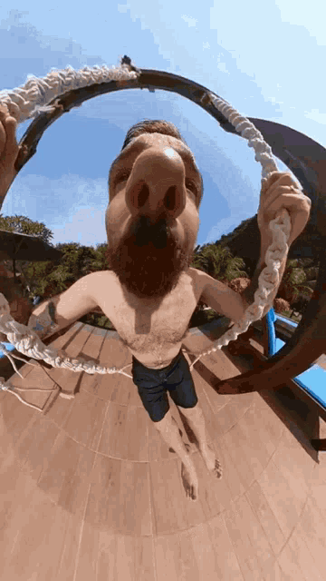a man with a beard is holding a rope around his face