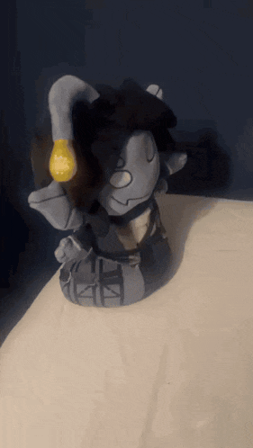 a stuffed animal with a yellow light bulb in its hand