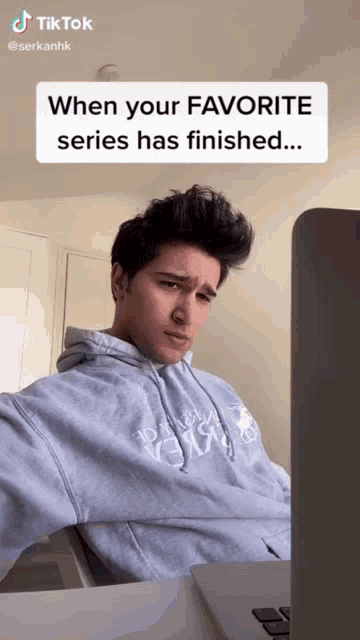 a man is sitting in front of a laptop with a tiktok sticker above him that says when your favorite series has finished ...