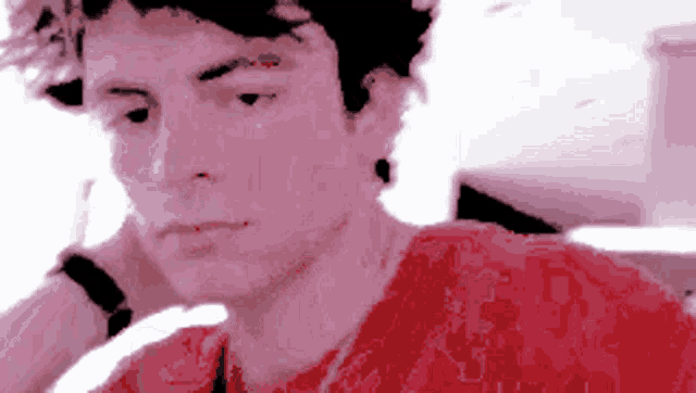 a pixelated image of a man with a red shirt