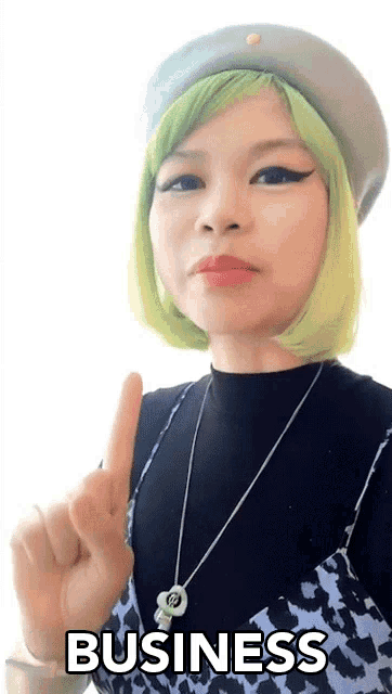 a woman with green hair is pointing up and the word business is visible