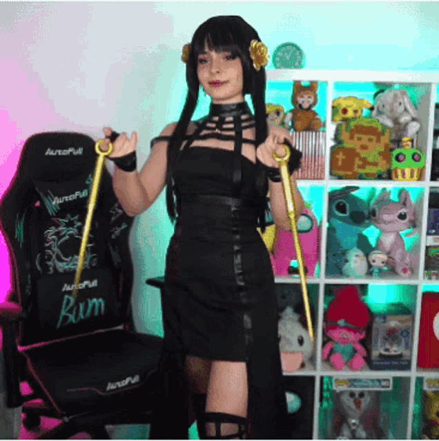 a woman in a black dress stands in front of a chair with the word bum on it