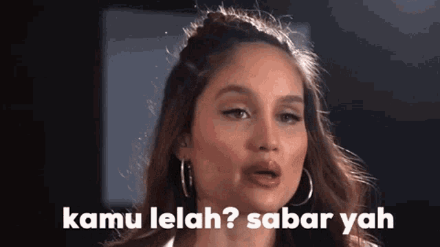a close up of a woman 's face with the words kamu lelah ? sabar yah .