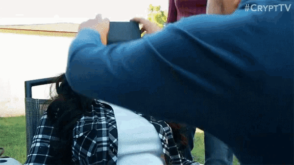 a man is taking a picture of a woman with the crypt tv logo visible