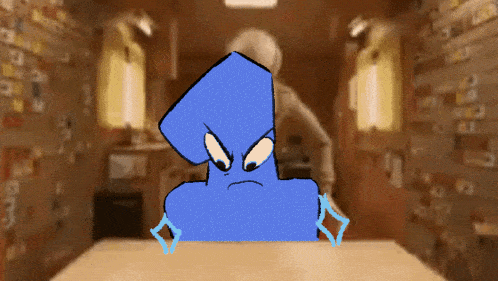 a blue cartoon character is sitting at a table in a dark room