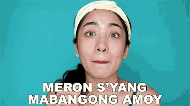 a woman wearing a headband with the words " meron s'yang mabangong amoy " above her