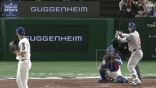 a baseball player getting ready to bat in front of a sign that says guggenheim