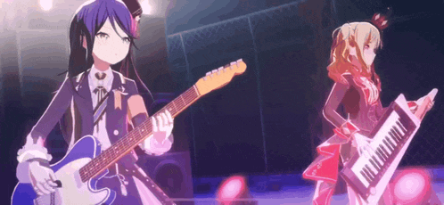 a girl is playing a guitar and a girl is playing a piano on a stage .