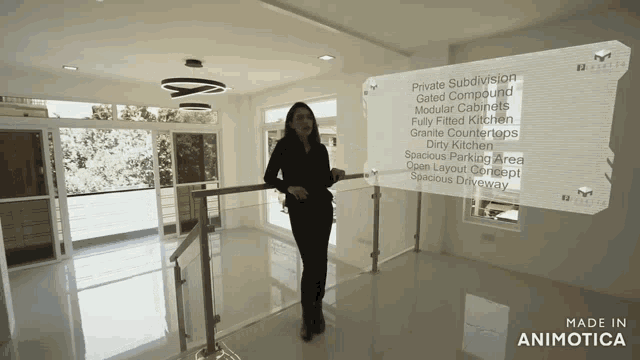 a woman is standing in a room with a sign that says made in animatica