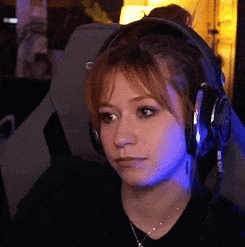 a woman wearing headphones and a black shirt with the letter c on it