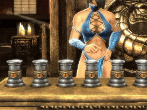 a woman in a blue top and blue gloves stands in front of a table with candles on it