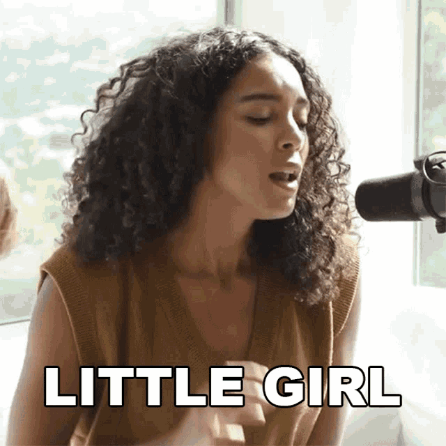 a woman with curly hair is singing into a microphone and the words little girl are visible