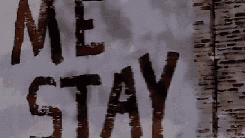 a sign that says " me stay " is on a brick wall